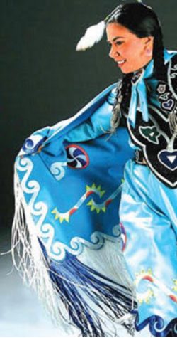 A Native American dancer dressed in traditional garb performs a tribal dance at the Indigenous Peoples Day celebration in Berkeley.  