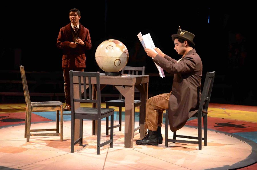Aditya Dhar (12) reads the newspaper while playing the protagonist character, Phileas Fogg, as Matthew Kennedy (11) speaks in the background. The Harker Conservatory is performing “Around the World in 80 Days,” a comedy musical about a British man traveling the world, for the 2016 fall play.