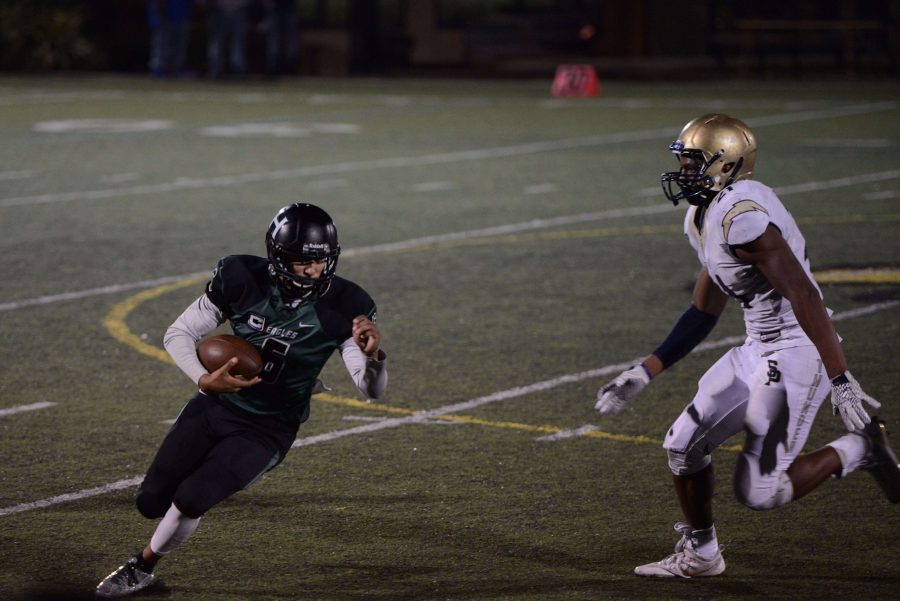 Quarterback Nate Kelly (11) tries to run the ball down the field himself during the second half. The Thunder raised their lead to 42 points during the second half of the game.