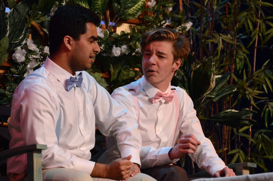 Aditya Dhar (12) and Brandon Stoll (12) have a conversation while sitting on a bench in The Importance of Being Earnest. The performance of this play was directed by Sana Aladin (12).