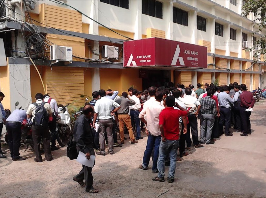 People at a bank line up to exchange or deposit their 500 and 1,000 rupee notes. People are limited to withdrawing 2,000 rupees in cash each week. 