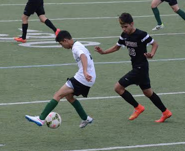 Captain Vedant Shah (11) attempts to fake out the opposing player with fancy footwork. The boys varsity soccer team defeated Eastside 2-0.