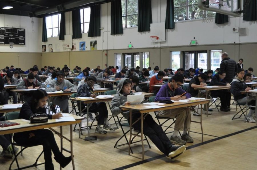 Students complete the 2014 AMC 10 and 12 exams. The tests are administered annually on campus in February; while the 2014 exams were taken in the gymnasium, this years exams were taken in Nichols Atrium.