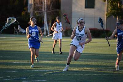 Captain Alayna Richmond runs with the ball. The varsity girls lacrosse team won their first regular season match against Newark Memorial High School 10-3.