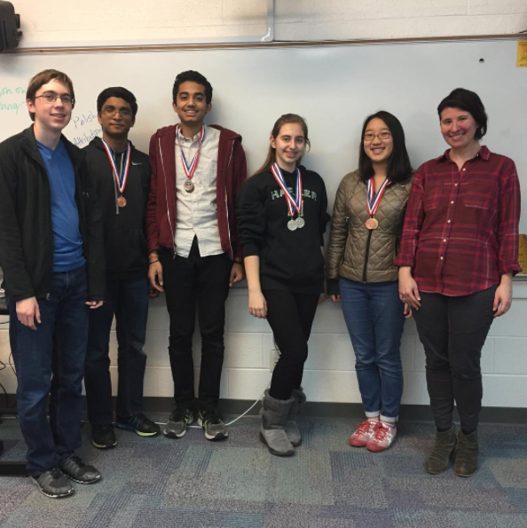 The Harker Academic Decathlon team and team advisor Michelle Andelman pose for a group photo in Ms. Andelmans room. The team earned a total of 14 awards at the regional competition on Jan. 14. 
