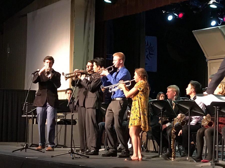 Four upper school trumpet players, along with Lab Band director Dr. David Hart, perform solos at the front of the stage. Lab Band, along with Jazz Band and groups from the Middle School, performed at the An Evening of Jazz concert on March 17.