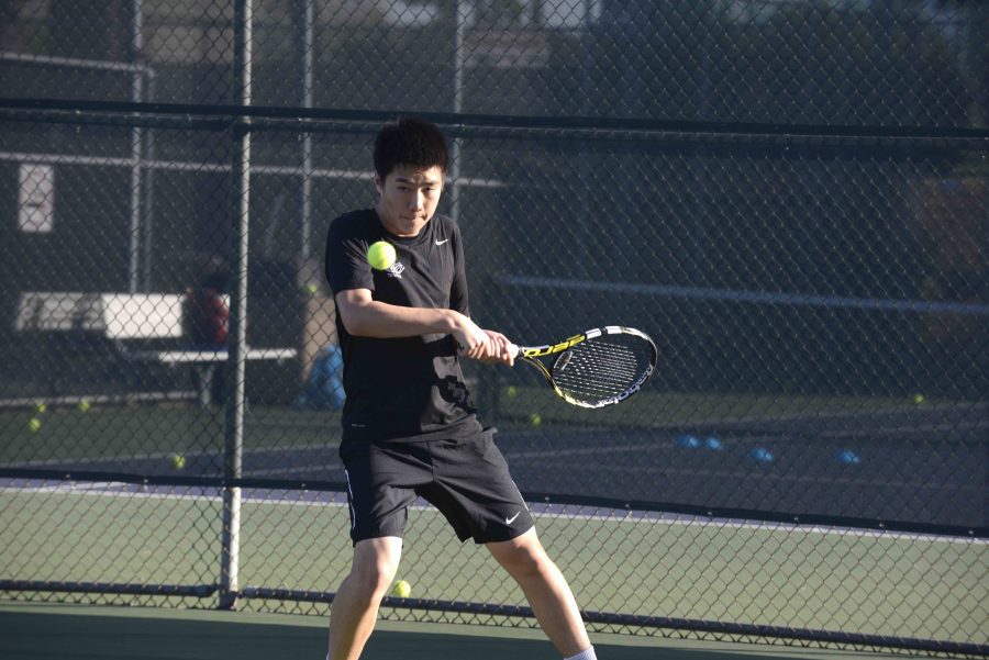 David Wen (11) hits a backhand. He plays number one singles for the Harker varsity boys tennis team. 