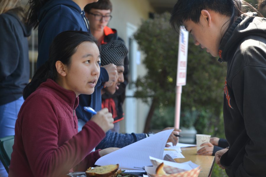 Honor council member Millie Lin (11) registers Justin Xie (11) for last Friday's council elections. The sophomore class held a reelection today to vote again on their honor council representatives and plan to vote on a new class secretary soon.