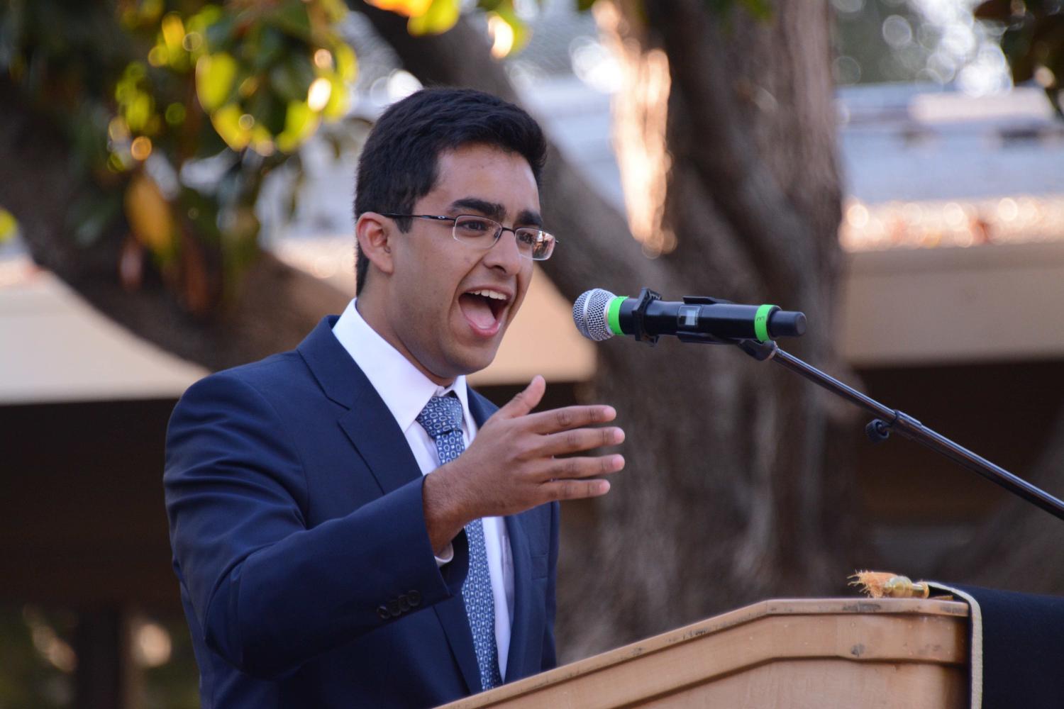 Baccalaureate student speaker Aditya Dhar (12) makes a joke during his speech. “As we go further and further down our own paths, our options start to narrow. We have to solidify what we want to study, We have to solidify what our plans are after graduation, what is we want to do in life, but the only way that you can set out on your own path is if you take all the opportunities, he said.