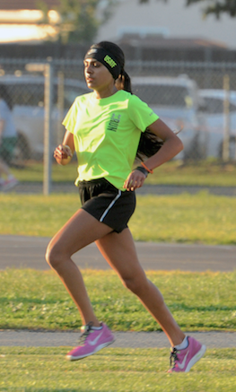 Niki Iyer (10) and Jack Rothschild (11) run laps around the Blackford field as a part of their preseason conditioning. Track and Field practice will begin on Feb. 2, 2015, at Blackford.
