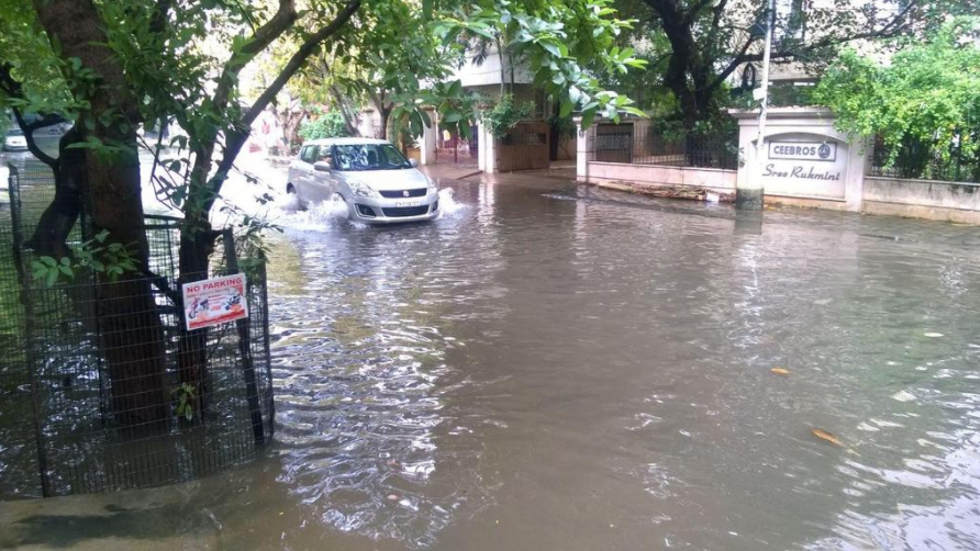 A car sits in a flooded parking lot during the 2015 Chennai floods. Two years later, both Chennai and Mumbai are experiencing heavy flooding and rains.