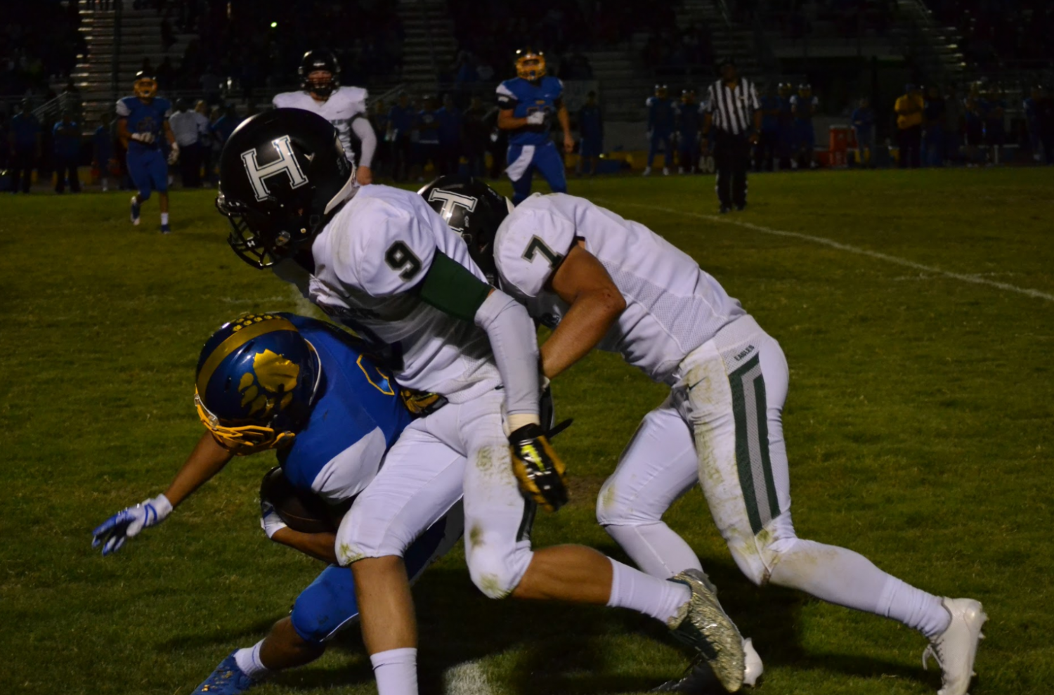 Anthony Contreras (12) and Jared Anderson (11) tackle a Santa Clara player running the ball. Both Anthony and Jared scored touchdowns during the first half of the game.