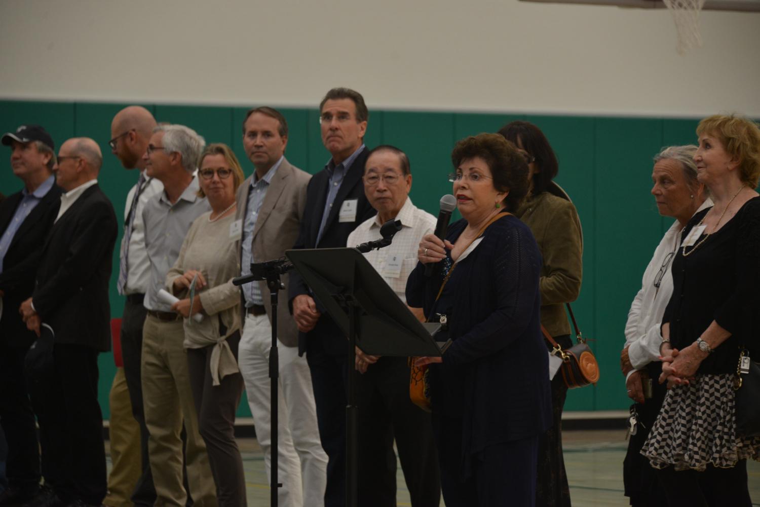 Chair of the Board of Trustees Diana Nichols delivers her opening remarks at the athletic center's opening ceremony. The court of the gymnasium is dedicated to former Head of School Howard Nichols, whose name is printed on the gym floor.