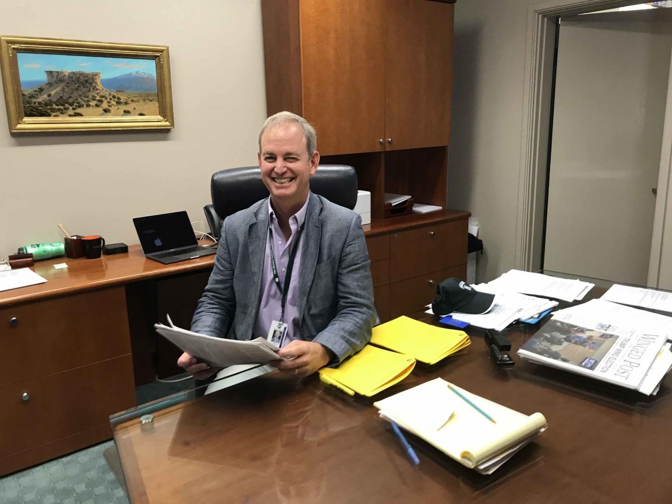 Head of School Brian Yager reads a copy of the Winged Post published in the previous school year. Yager joins Harker as the new Head of School starting this year.