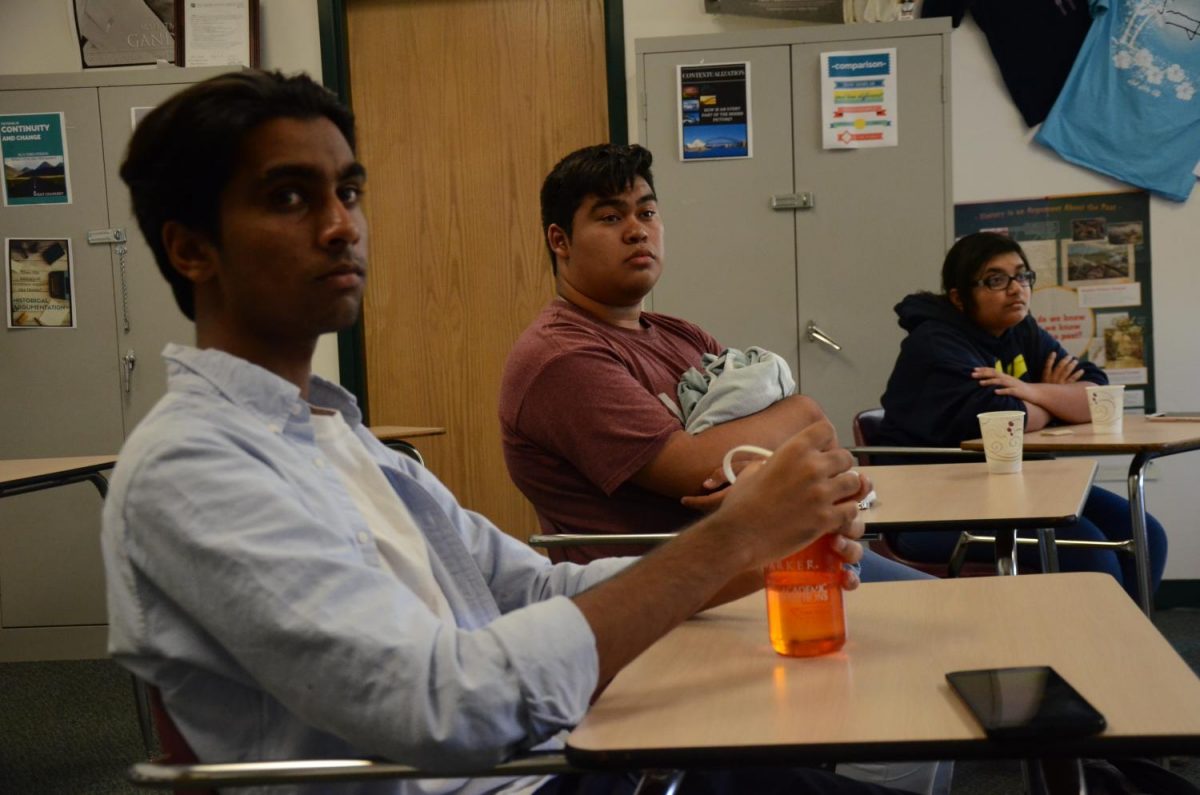 Adyant Kanakamedala (12), Felix Roman (12) and Deb Chatterjee (12) listen as history teacher Mark Janda shares his thoughts on Ta-Nehisi Coates article in The Atlantic Magazine. Janda and fellow history teacher Carol Green hosted this Shah Salon in Jandas room today.