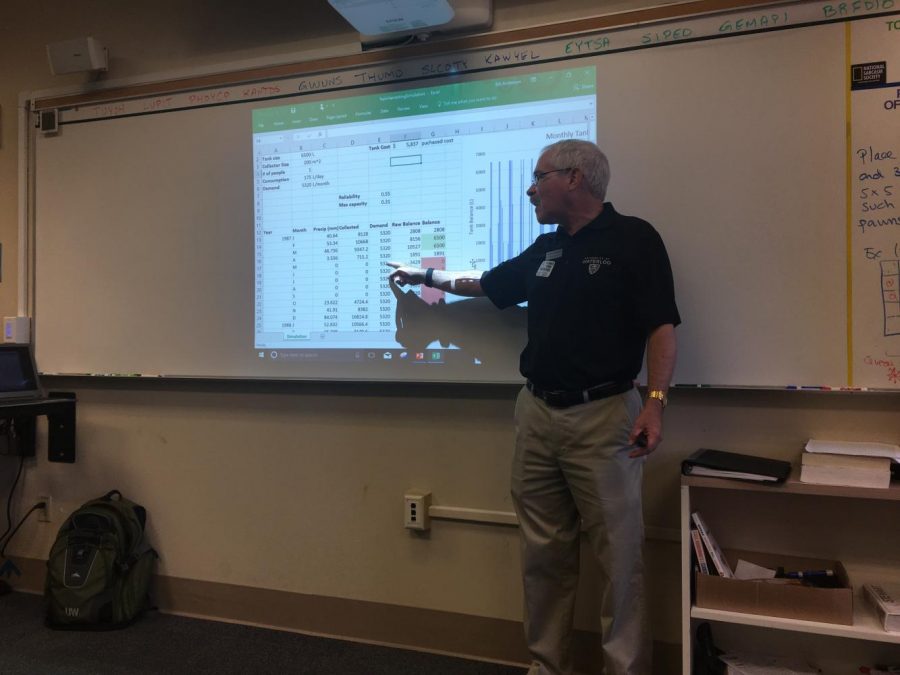 Professor Bill Anderson points to a spreadsheet during his presentation. Anderson discussed engineering and design for two fifth-period math classes. 
