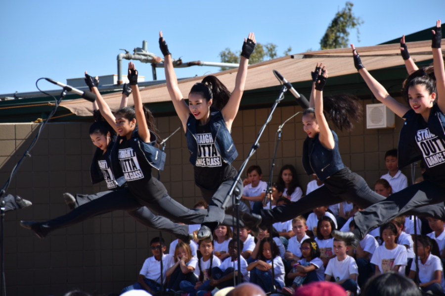 The JV dance team performs a routine at a previous years picnic. This years picnic is themed Harker Hoedown.