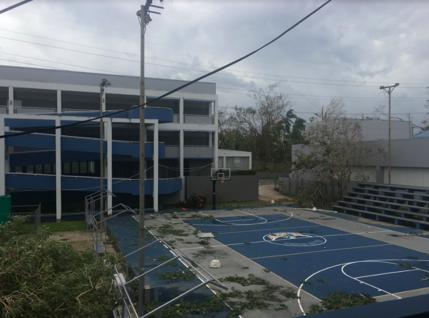 A basketball court is shown littered with trees after Hurricane Maria hit Puerto Rico. After a month following the hurricane, the area still remains in devastating conditions. 