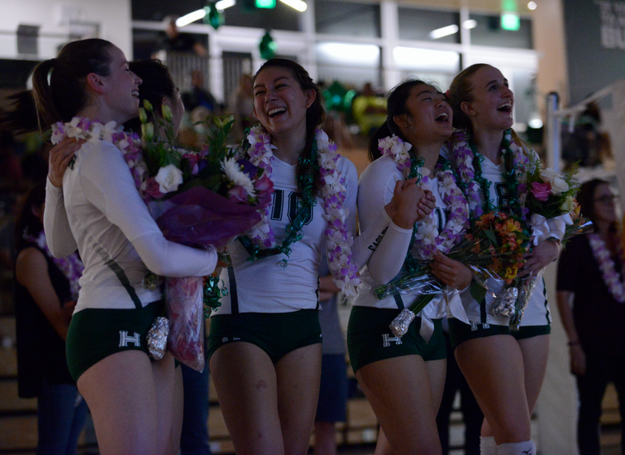 Seniors Lauren Napier, Melissa Kwan, Megan Cardosi, Tiffany Shou and Isabella Spradlin laugh while watching a video honoring their achievements. All five seniors have played volleyball all four years of high school.
