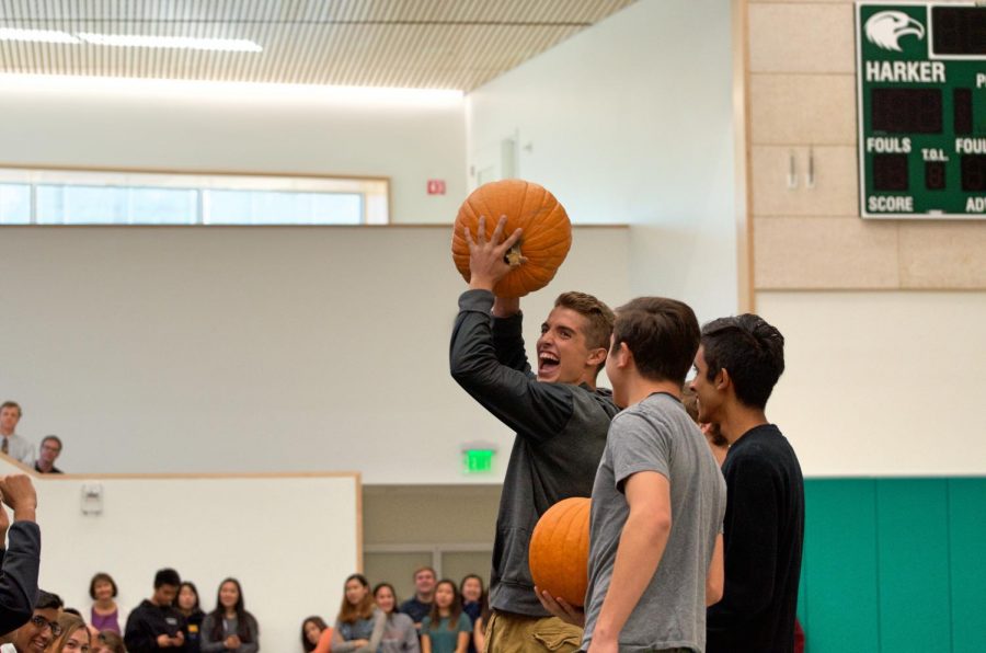 Anthony Meissner (11) raises his chosen pumpkin into the air during todays school meeting. Pumpkins for this Fridays pumpkin carving contest were chosen by representatives from each grade level in order of seniority.