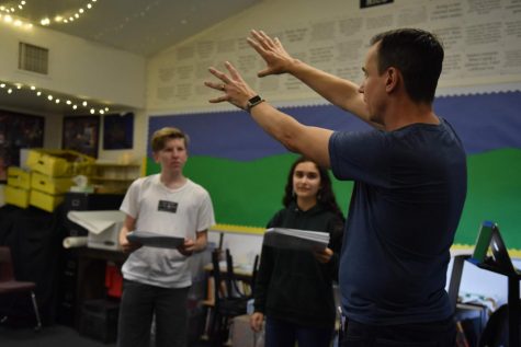Director Jeffrey Draper explains the layout of a scene to the cast during rehearsals. The play is five acts long and has a run time of about two hours.
