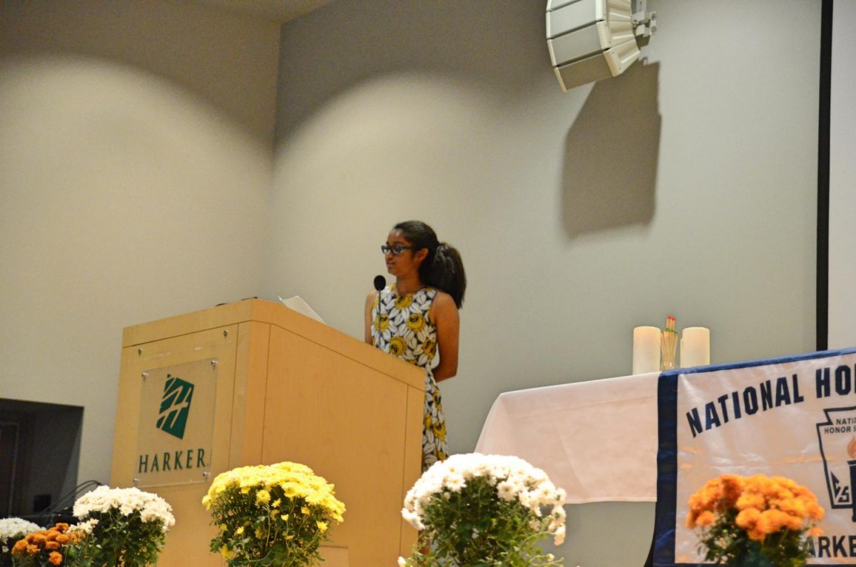 NHS vice president Tanvi Singh (12) reads off the names of this years 79 NHS inductees. Academic Dean Evan Barth handed induction certificates to the inductees after they walked across the stage.