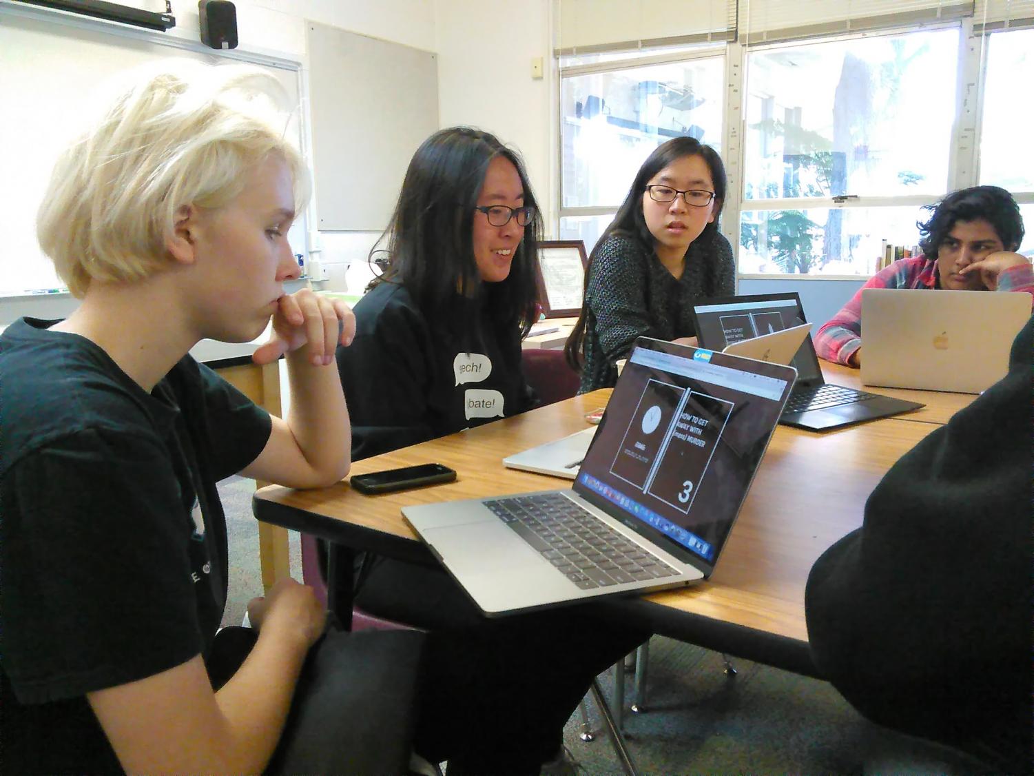 Elliot Kampmeier (9), Serena Lu (12), Gwyneth Chen (12) and Amla Rashingkar (10) review student work during one of HELM's workshops this week. HELM members also sold boba tea outside Manzanita on Tuesday, Wednesday and Friday for $5 each.