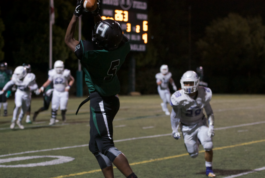 Floyd Gordon (12) catches a pass to score a touchdown. So far, the varsity football team is undefeated in their season.