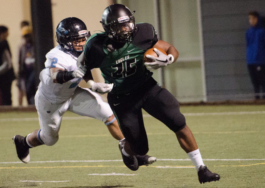 Aaron Smith (11) attempts to outrun a Hercules player. The football team ended the season with eleven wins and one loss.