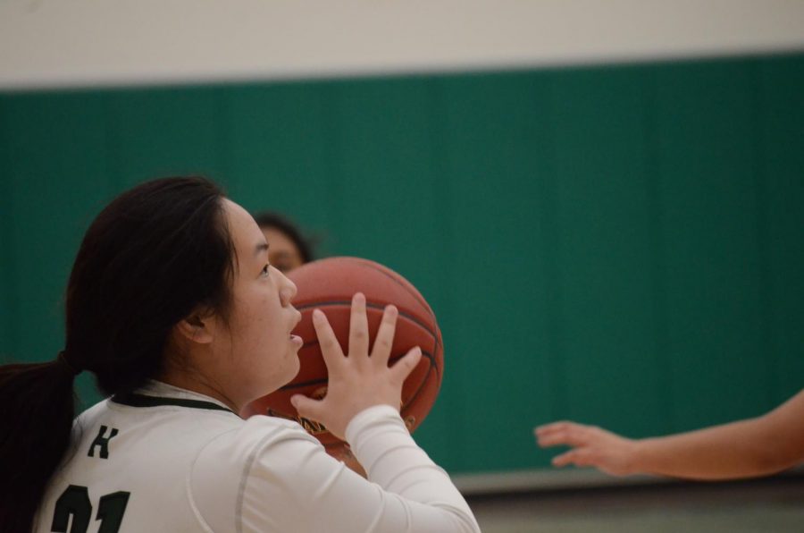 Junior Jennifer Hayashi gets ready to shoot the ball during the home game against Crystal Springs Uplands. This is the first basketball season in which the teams utilized the new athletics center. 