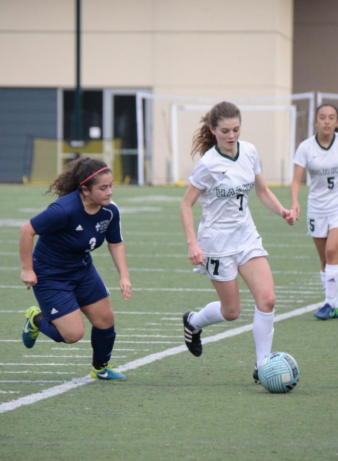 Dribbling the ball between her feet, Sarah Baicher (9) avoids a defender while running down the sidelines. The varsity girls team won against Notre Dame San Jose High School 2-1 on Wednesday. 