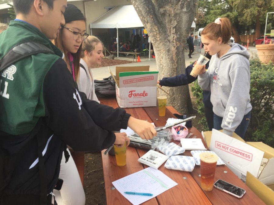 Jeffrey Liu (10) and Alisa Su (12) purchase Teaspoon from the United Against Animal Cruelty table outside Manzanita. “I hope that in the future, this club will be a good way to stand up for animals and branch out to others just so they have some level of care for the issues we’re talking about. Hopefully in the future, we’ll be able to do more things on-campus and off-campus that promote that message and mission, Haris Hosseini (11), the clubs social media manager, said.