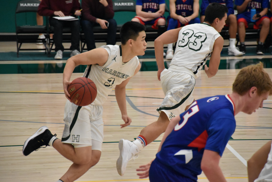 Junior Gene Wang dribbles across the court in the home game against Crystal Springs Uplands. They won the game by a margin of 36 points. 