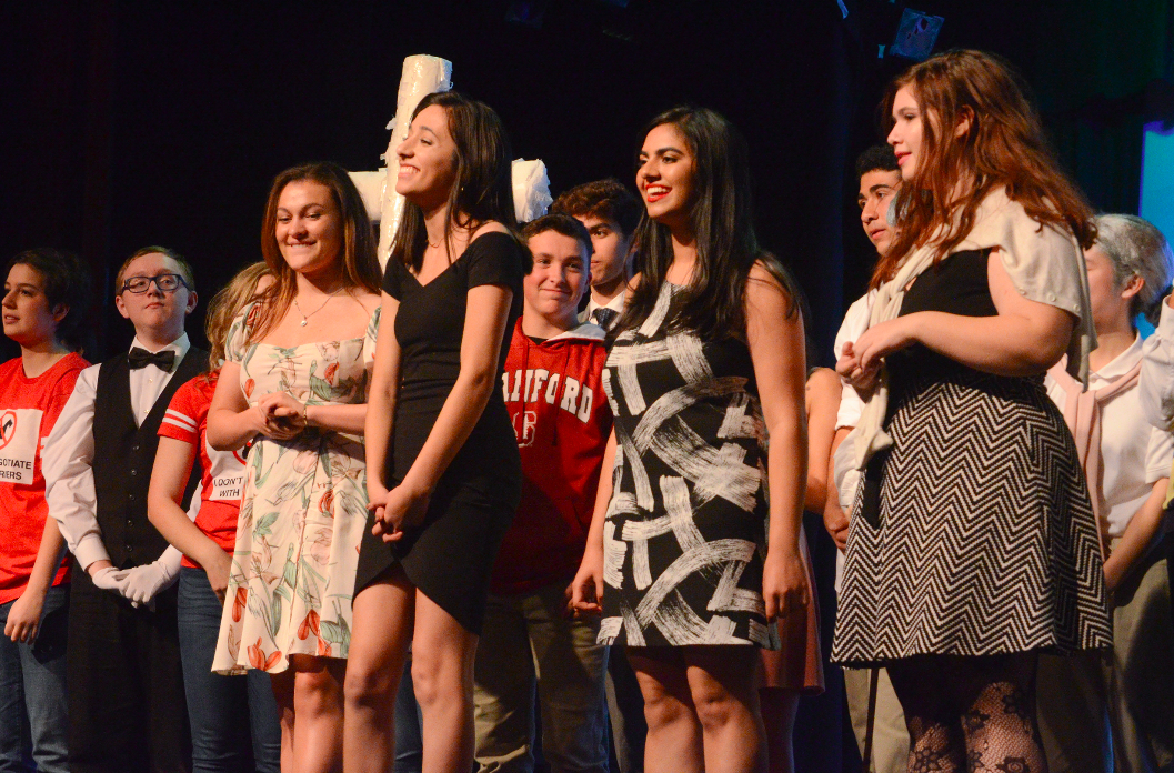 SDS directors Haley Keller (12), Sameep Mangat (12), Anika Banga (12) and Jessica Skinner (12) meet with their casts onstage at the end of Saturday's performances. This year's SDS was presented at the Blackford theater yesterday and today.