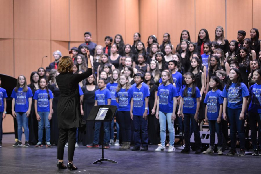 The performing vocal groups from all three campuses return to the stage to sing the Harker School Song. They invited the audience to sing along with the lyrics provided in the concerts program.