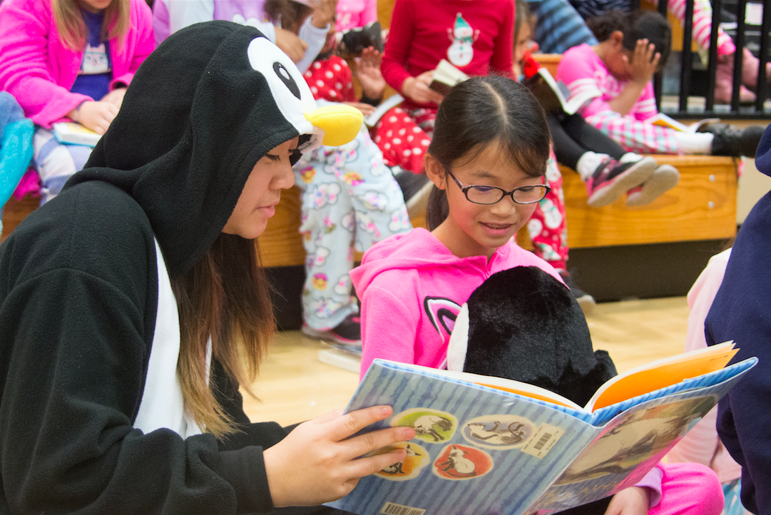 Amanda Cheung (10) reads a book about cats to her buddy. The sophomores met with their Eagle Buddies at the Bucknall campus, where they donated children's books to the lower school's ongoing pajamas and books drive and decorated corner bookmarks.