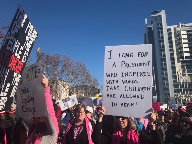 Crowds hold up signs during the Womens March 2018, which took place on Jan. 20. This date was the anniversary of President Trumps inauguration.