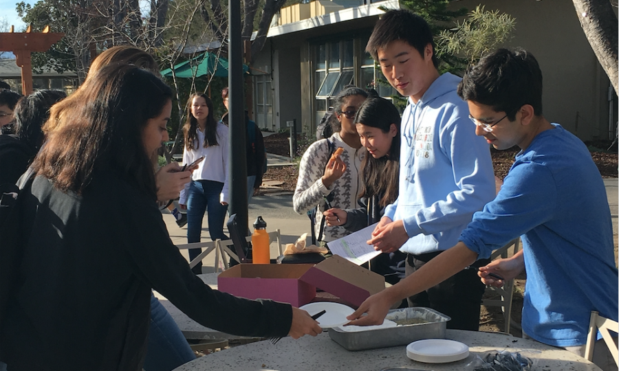 SNHS members David Wen (12) and Ayush Alag (11) distribute paper plates and plastic utensils to students purchasing baked goods from their table outside Manzanita. Club members sold tres leches cake, churros and Mexican hot chocolate to raise money for the Sunday Friends organization, a non-profit based in San Jose that offers day-long programs on Sundays to low-income families in the area on financial literacy, health and nutrition, violence prevention and basic computer skills.
