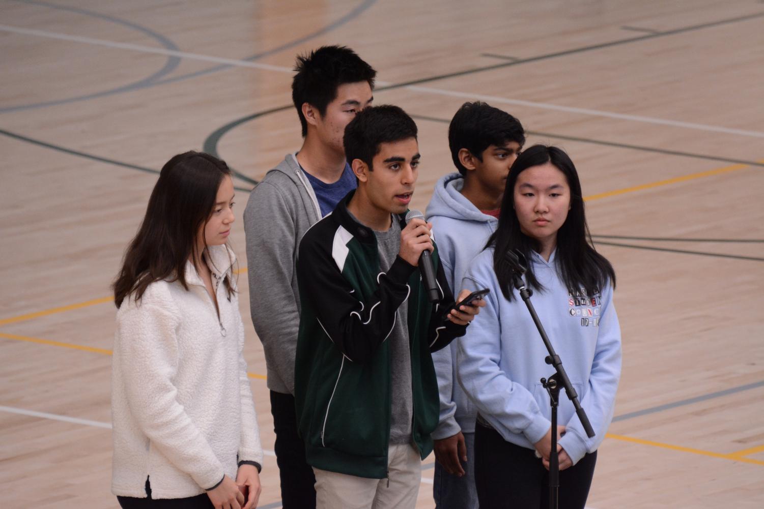 Student council members Alycia Cary (11), David Wen (12), Avi Gulati (10), Akshay Manglik (9) and Kat Zhang (11) announce details about the upper school's upcoming support and advocacy initiatives in response to the recent Marjory Stoneman Douglas (MSD) shooting. Among these efforts include an optional vigil in the athletics center this Wednesday and a gun debate and town hall at 3:15 p.m. in Nichols Auditorium on March 23.