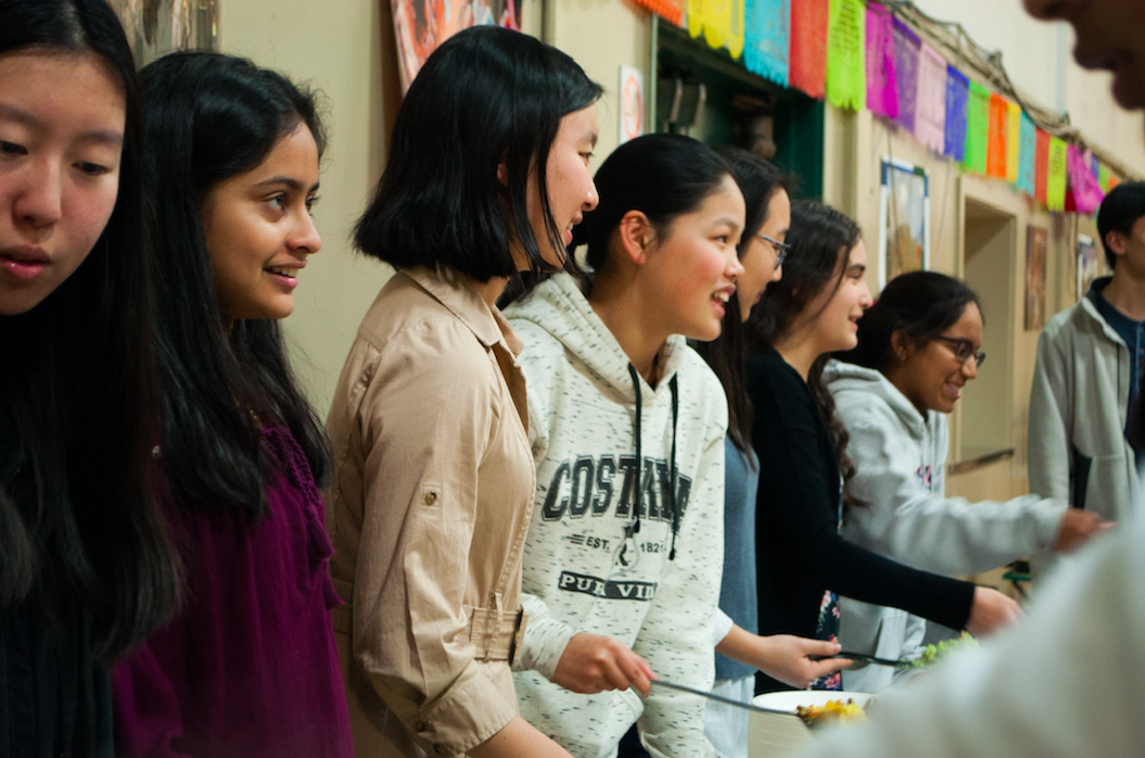 Spanish National Honor Society members serve paella to Spanish Cultural Night attendees. The event was hosted in the auxiliary gym from 6 to 8 p.m. today.