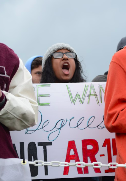 Senior Sumi Wadhwa holds up a poster saying “we want degrees, not AR-14’s” at March for our Lives San Jose. Several upper school students and teachers took part in the protests in San Jose and San Francisco on March 23. 