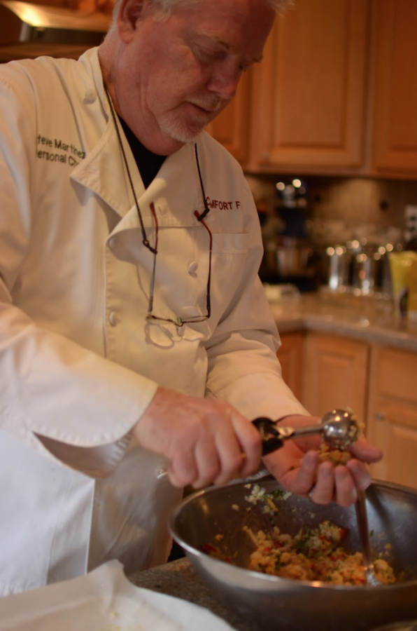 Chef Steve mixes vegetables in a bowl after washing them. Though comfort food is often associated with greasy and unhealthy food, Martinez says, “My purpose in naming my
company that was just the notion of food being nourishing and comforting.” 