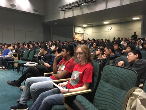 Programming club officers Rakesh Nori (10) and Alexandra Michael (12) sit in the audience before a talk. The club hosted talks and also featured a keynote speaker.