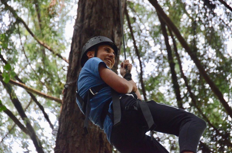 High up in the treetops, a member of the class of 2021 grips a rope for support during the sophomores’ ropes course trip in the Santa Cruz Mountains on Aug. 23. The classes of 2020 and 2021 participated in off-campus trips on Aug. 23.