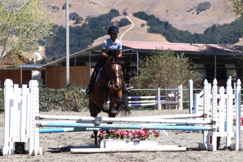 Nilisha Baid (10) and her horse Manny jump over a hurdle. After years of developing skills and enjoying horses, Nilisha joined the competitive program for horseback riding last year.
