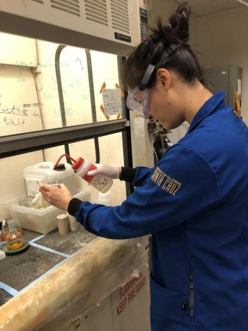 Allison Cartee (12) performs a chemistry experiment under a glass hood at UC Santa Cruz. Allison was a member of the Summer Internship Program (SIP) at UCSC and spent ten weeks performing research under the guidance of a mentor.