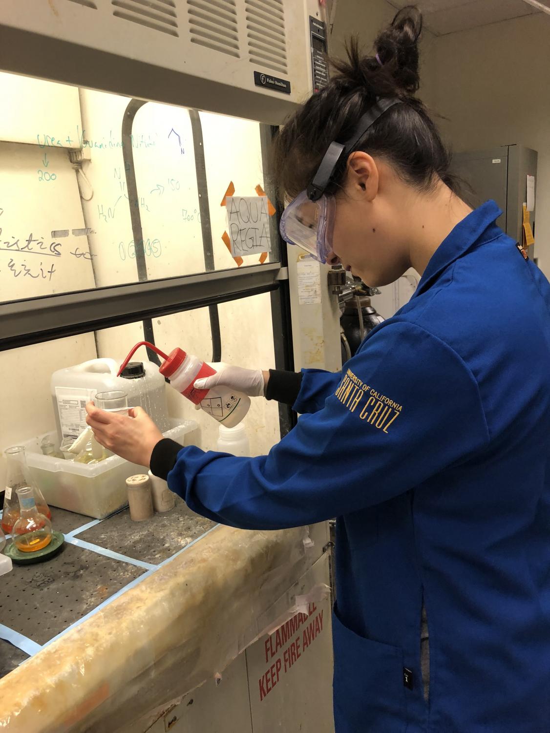 Allison Cartee (12) performs a chemistry experiment under a glass hood at UC Santa Cruz. Allison was a member of the Summer Internship Program (SIP) at UCSC and spent ten weeks performing research under the guidance of a mentor.