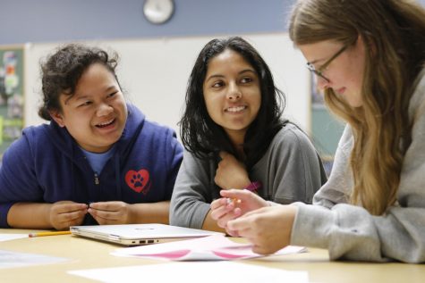 A team of students discusses one of the algorithmic programs from the contest. The Girls Programming League Challenge was hosted by the eponymous organization on Sept. 8.