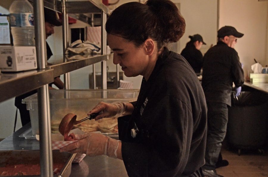 As vegan diet mounts in popularity, vegan meal options accommodate most lifestyles. A kitchen staff member prepares a vegan dish.