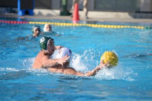 Matthew Hajjar (12) reaches for the ball, playing defense against a Cupertino player.  The first half finished 6-3 in favor of the Eagles, with Harker goals scored by Bobby and Matthew.